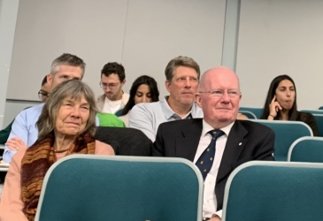 Participants sit in auditorium seating